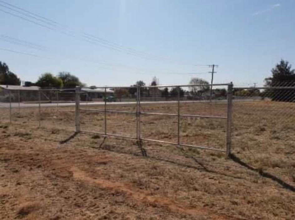 Galvanised gate in a chain link fence on a rural block