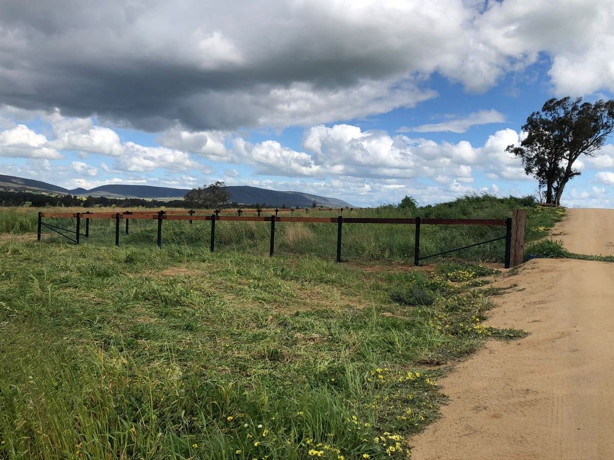 Rural wire fence along a paddock and farm track